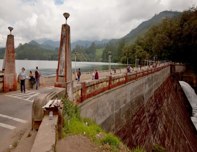 A serene view of the Mattupetty Dam with its calm waters and surrounding hills